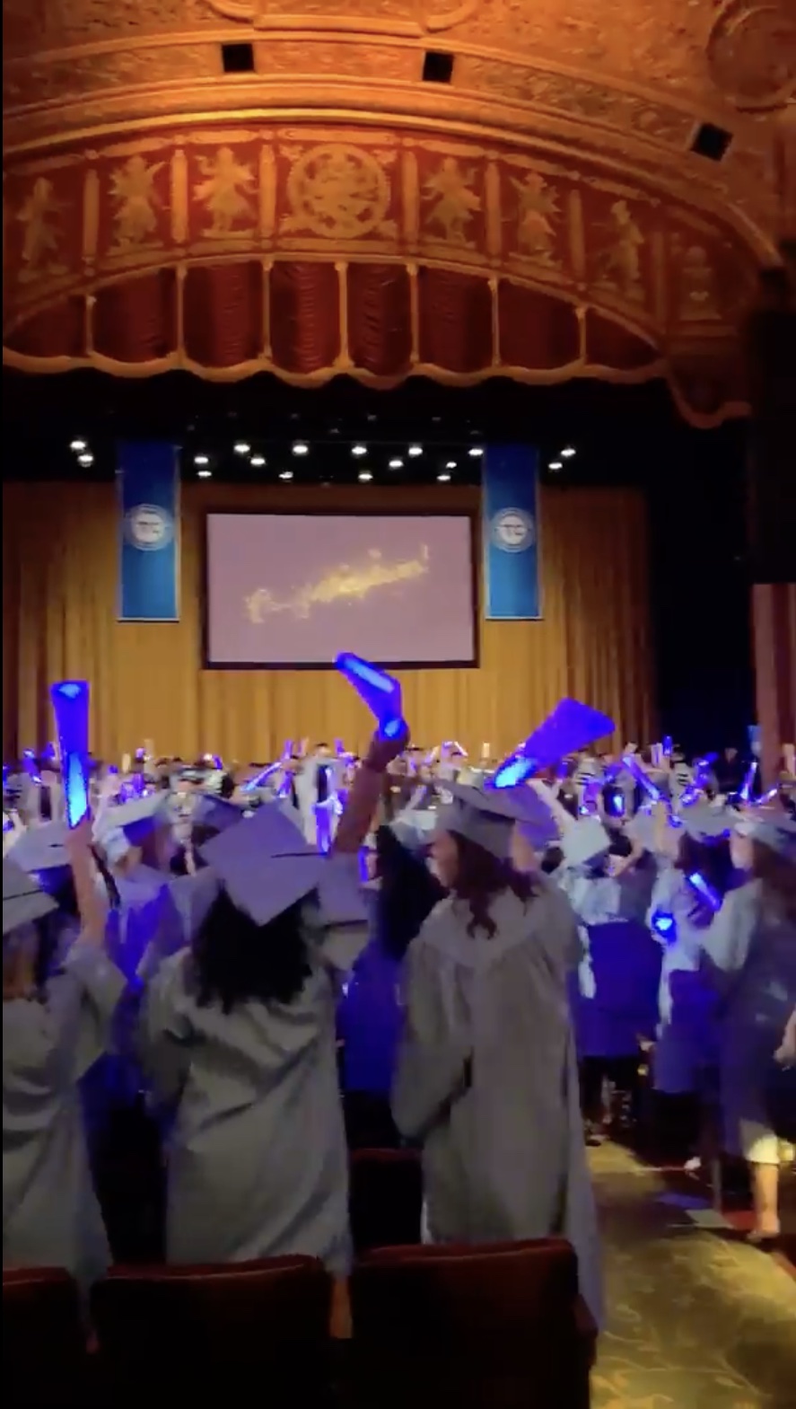 Graduates celebrating and cheering in the venue